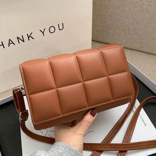 Brown quilted crossbody bag held by a hand with a 'THANK YOU' card in the background.