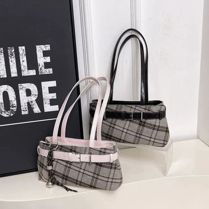 Two shoulder bags, one pink and one brown strap, on a white surface with a black and white background.