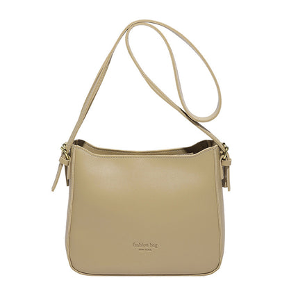 Beige handbag with a strap on a white background