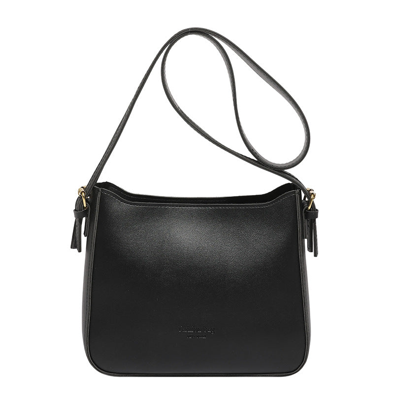Black leather shoulder bag on a white background