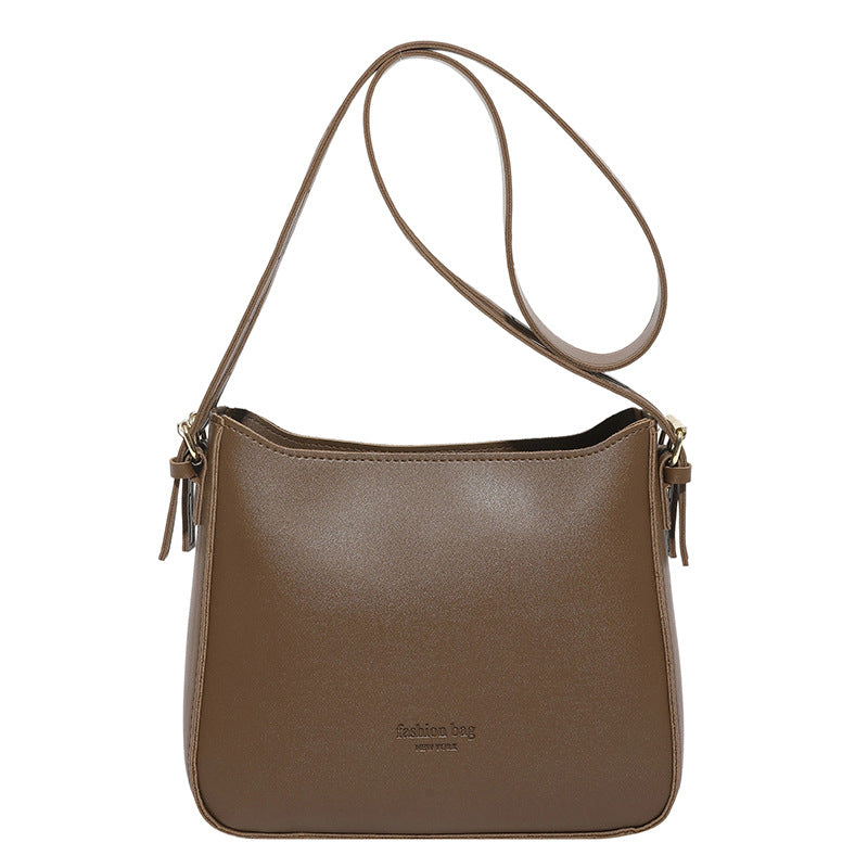 Brown leather shoulder bag on a white background