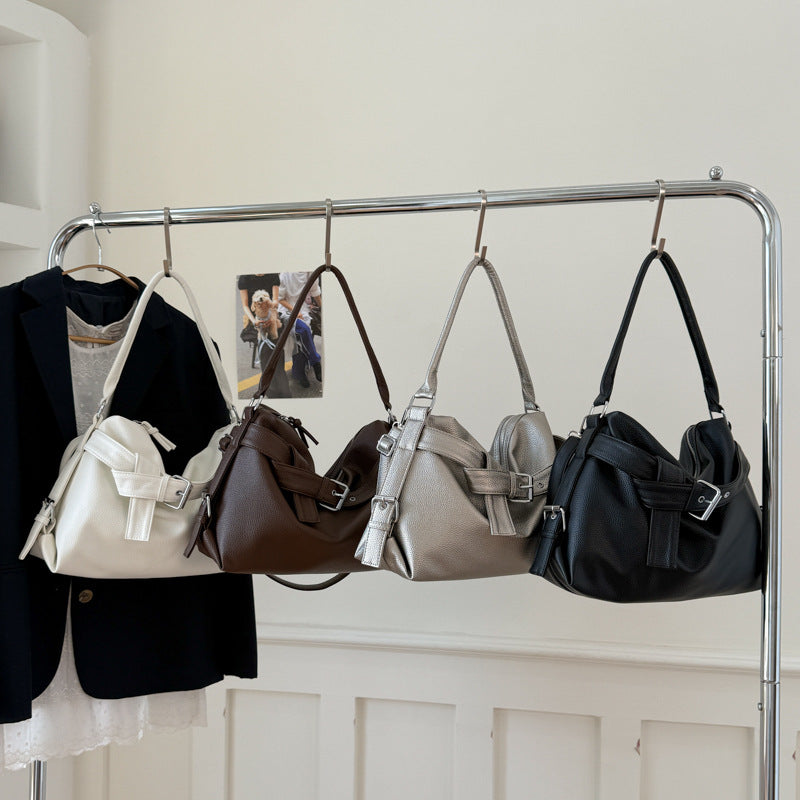 Four large retro tote bag women hanging on a rack with a neutral background