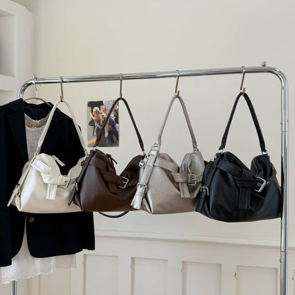 Four large retro tote bag women hanging on a rack with a neutral background