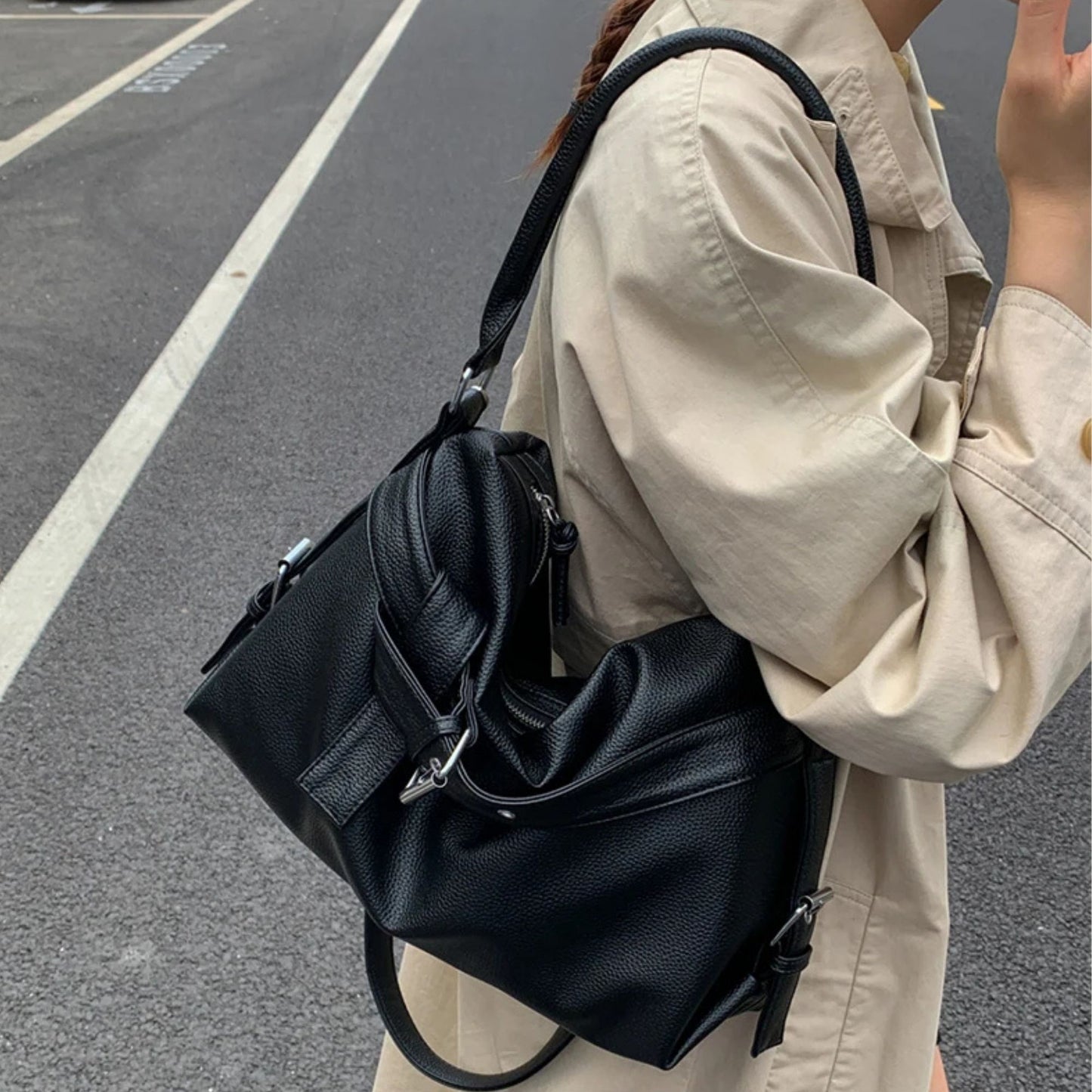 Person wearing a black large retro tote bag women on a street