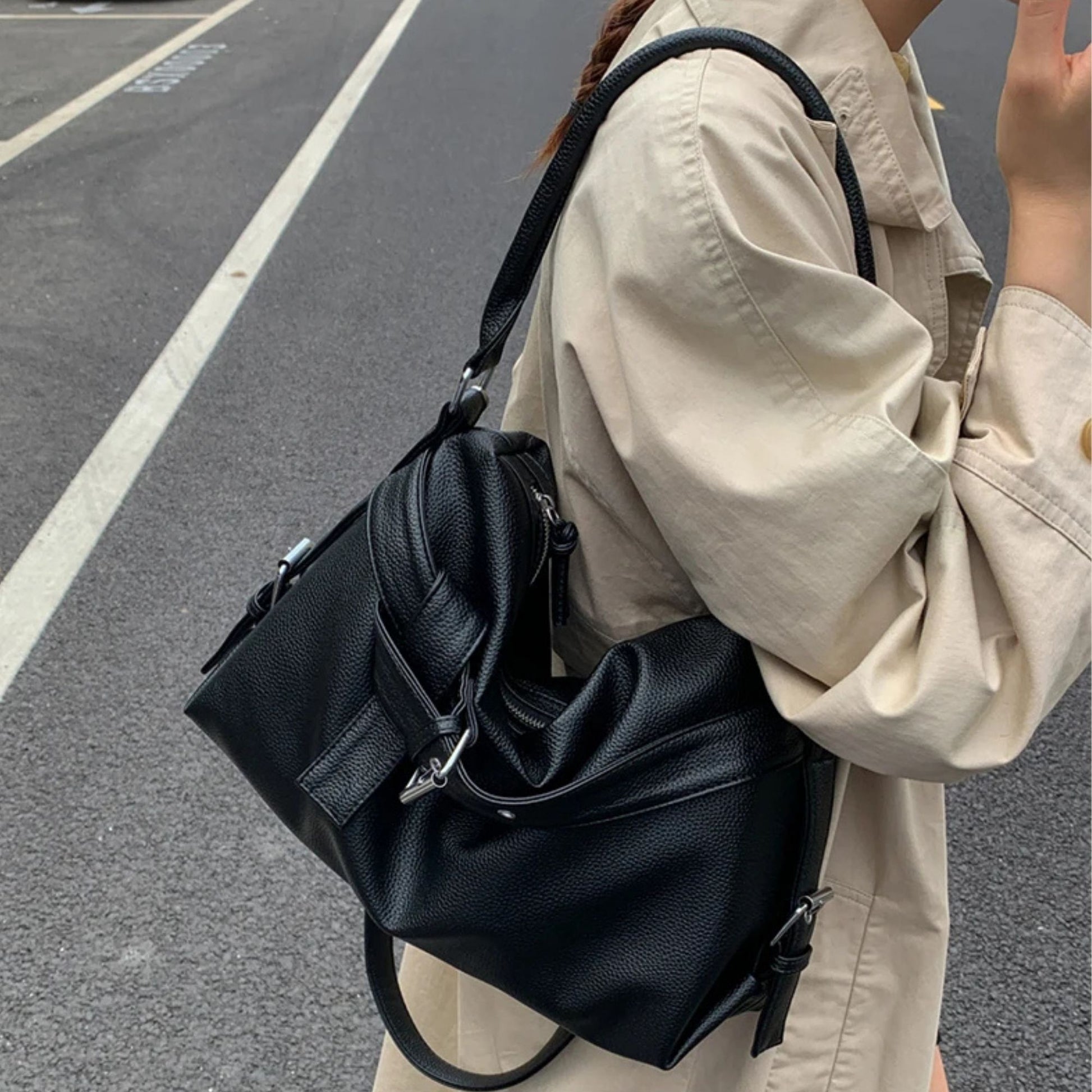 Person wearing a black large retro tote bag women on a street