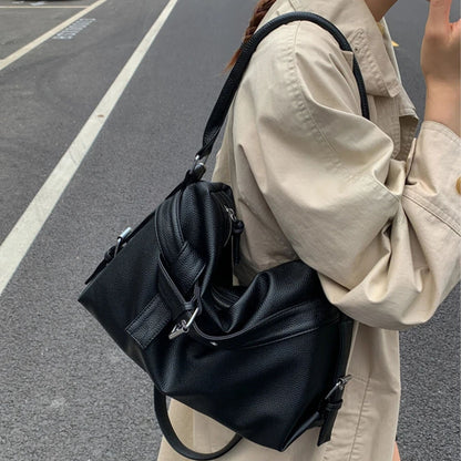 Person wearing a black large retro tote bag women on a street