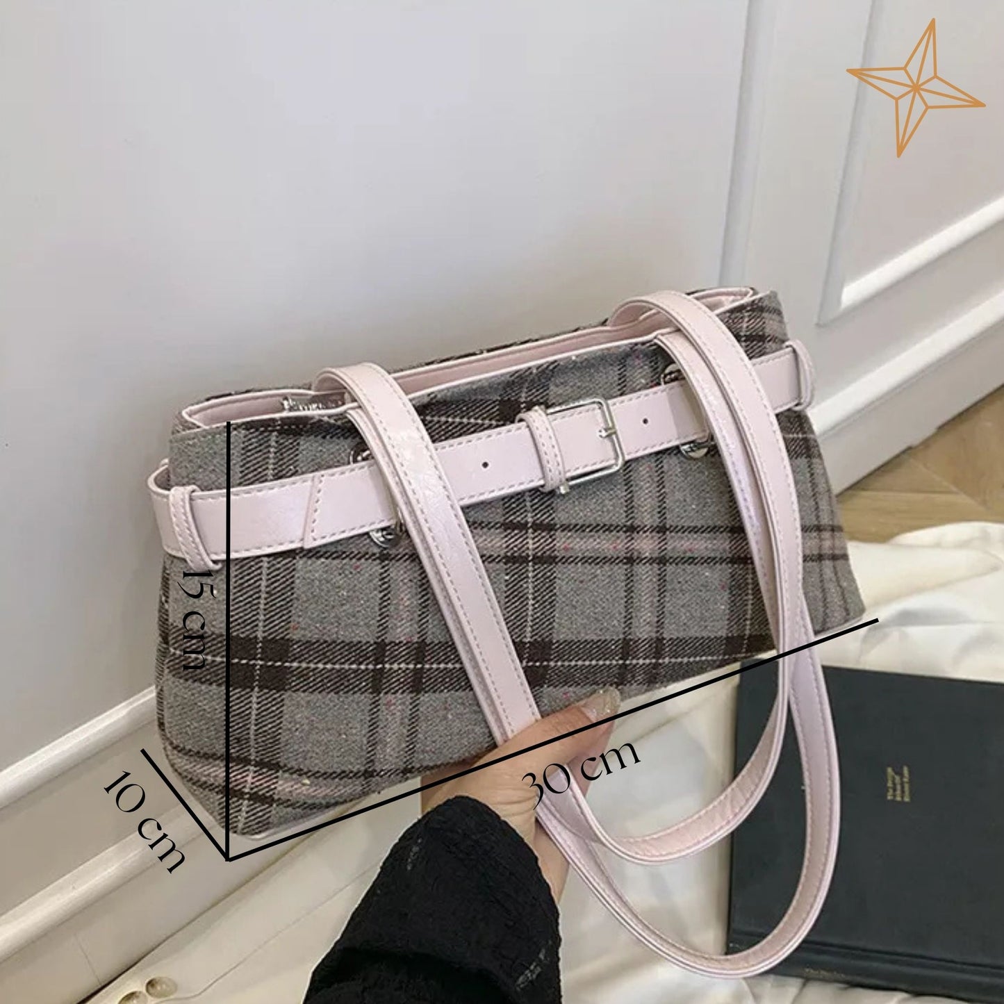 Plaid shoulder bag with pink straps held by a person, with measurements indicated.